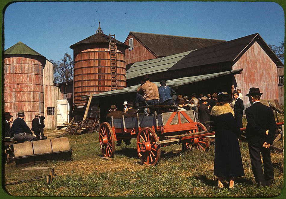 Image of people watching farmer on a tractor