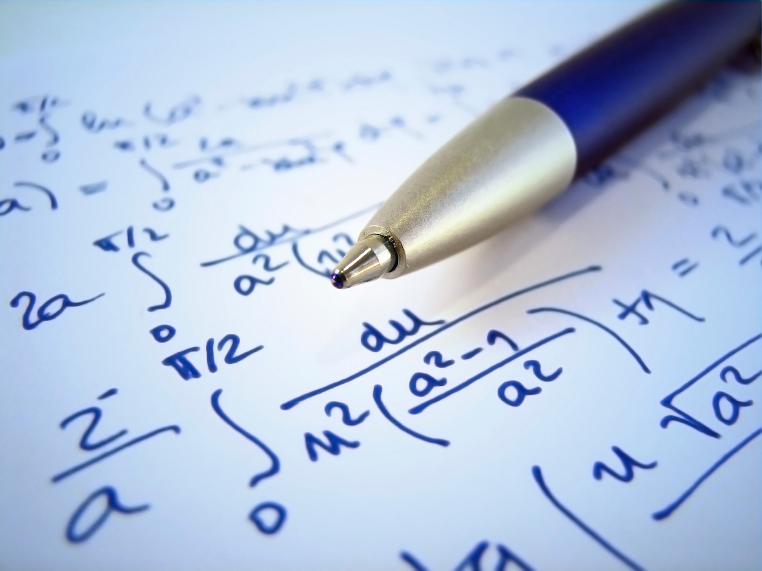 Pen and notebook with math equations