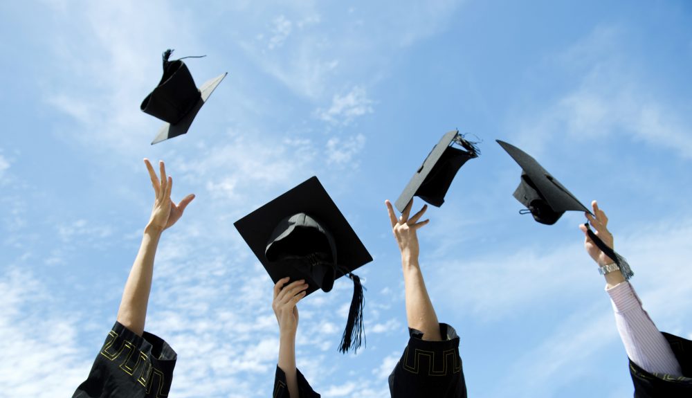 College graduation caps thrown in the air